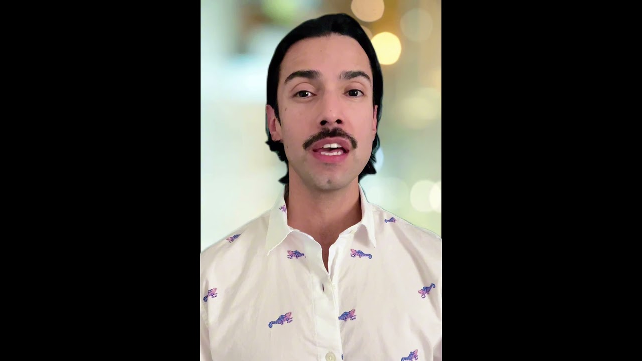 JohnRoss in a white shirt with playful pink and blue animal prints, speaking on how interior design choices influence the nervous system and emotional well-being.